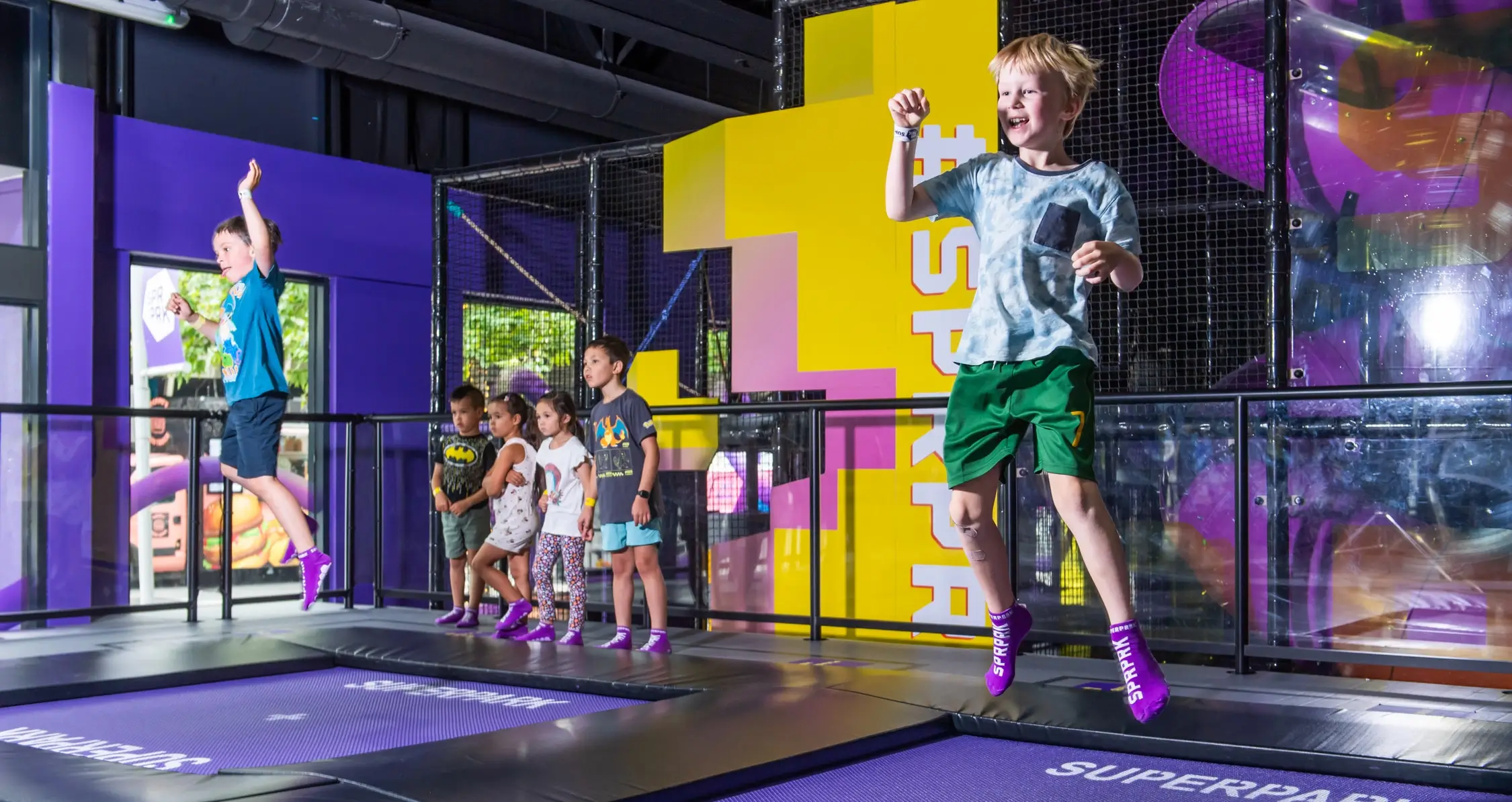 Young boy jumps on the SuperJump interactive trampoline